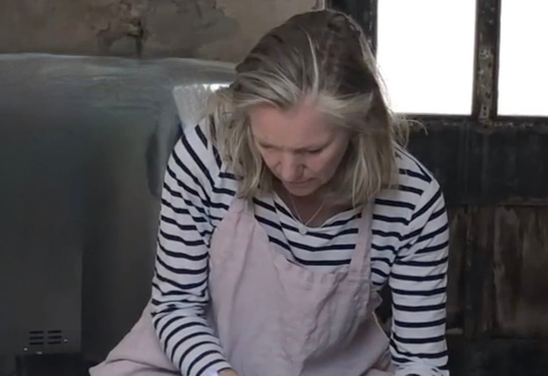Galloway based studio potter and maker, Ella McCreath at her potter's wheel.