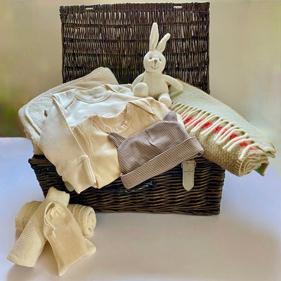 The St Andrews Hamper Company luxury baby hamper with 14 gorgeous organic and eco-friendly welcome to the world gifts including soft, cosy striped pure new wool pram blanket and handwoven wicker hamper.