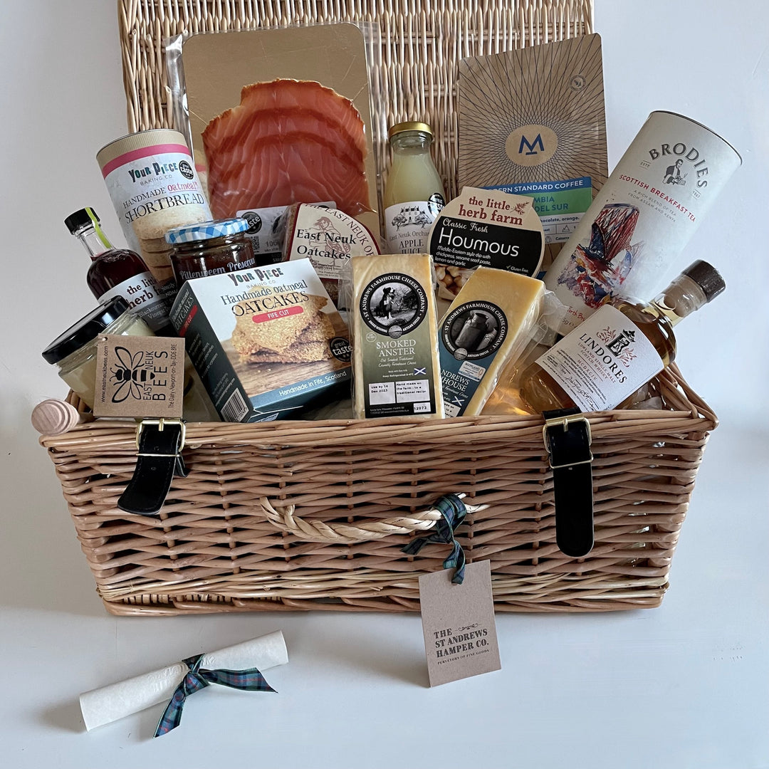 The St Andrews Hamper Company's Home of Golf Hamper filled with delicious eco and organic food and drink made in and around St Andrews. Available with a choice of spiced gin or single malt whisky both distilled locally and presented in a wicker hamper or jute tote.