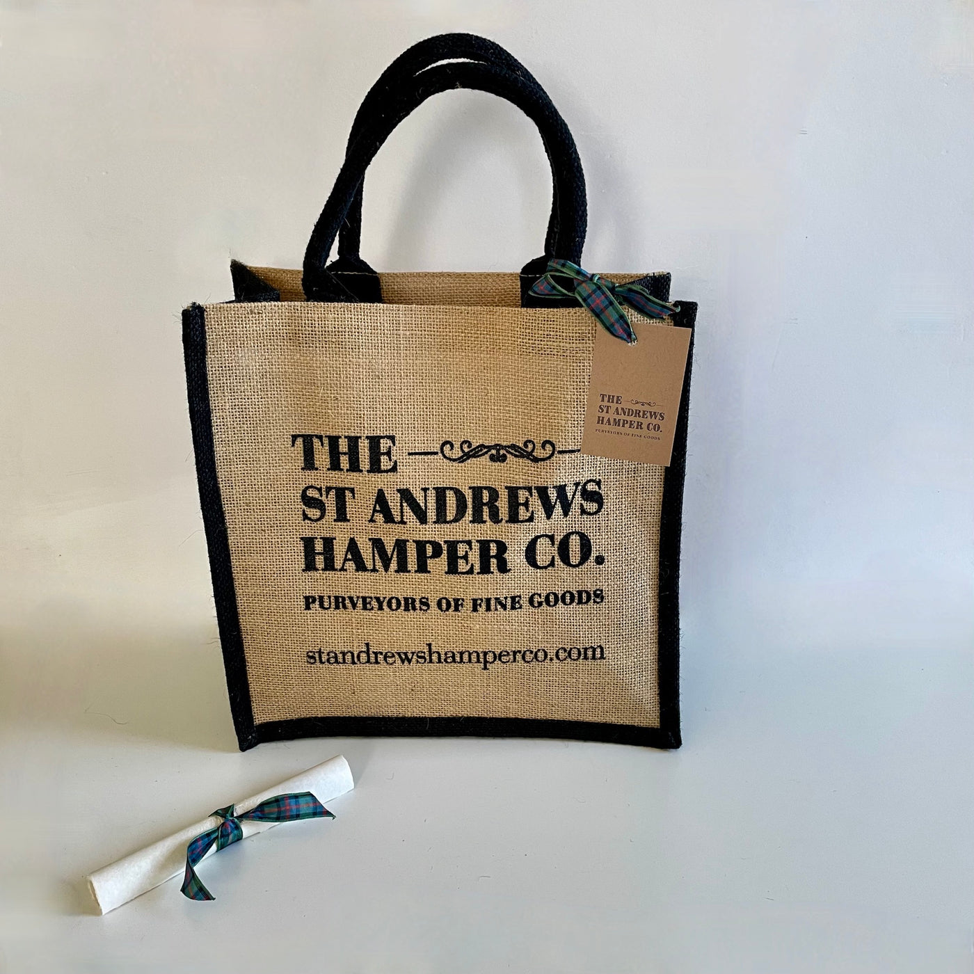 The St Andrews Hamper Company branded tote in natural jute with black trim.