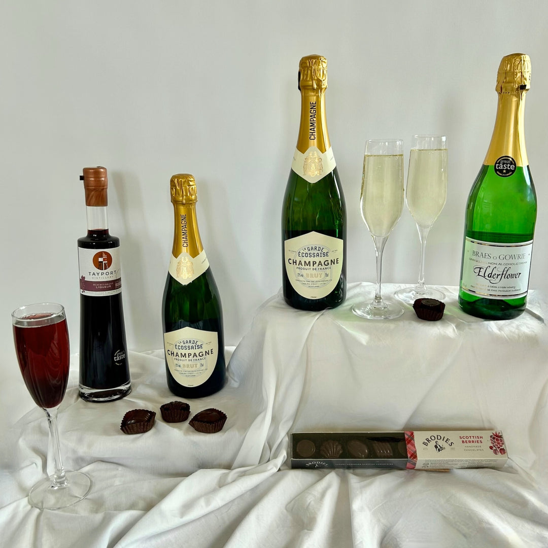Celebration bubbles hamper from the St Andrews Hamper Company featuring two bottles of premier champagne, award-winning blackcurrant Crème de Cassis  liqueur and non-alcoholic elderflower cordial and Scottish berries handmade chocolates, exclusively available from The St Andrews Hamper Company.