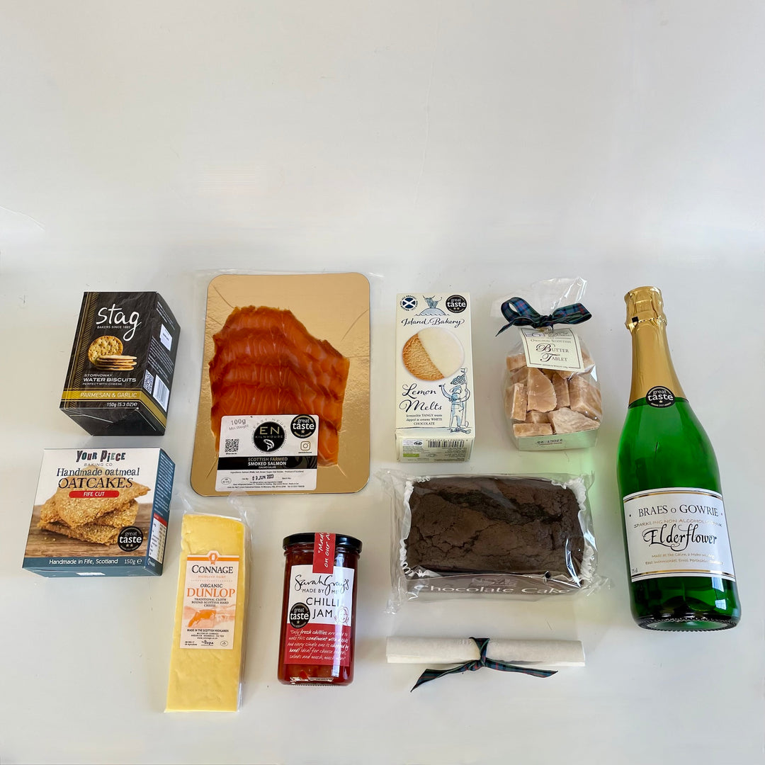Unique graduation gift hamper with nine sweet and savoury treats including a bottle of sparkling elderflower, carefully sourced from tried and trusted artisan suppliers based around Scotland, presented in our exclusive St Andrews Hamper Company canvas tote.