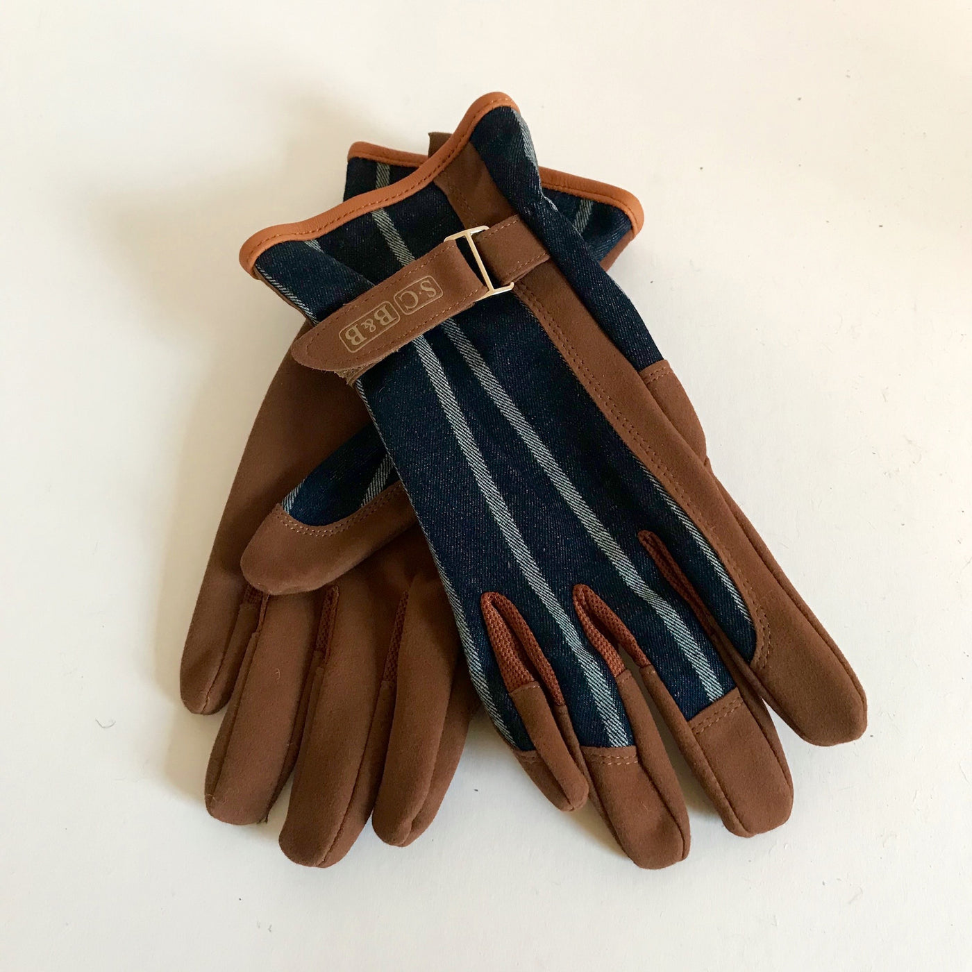 Rory & Ruby Sophie Conran one size gardener's gloves with blue ticking fronts, tan  ultra-soft faux leather and adjustable wrist straps.