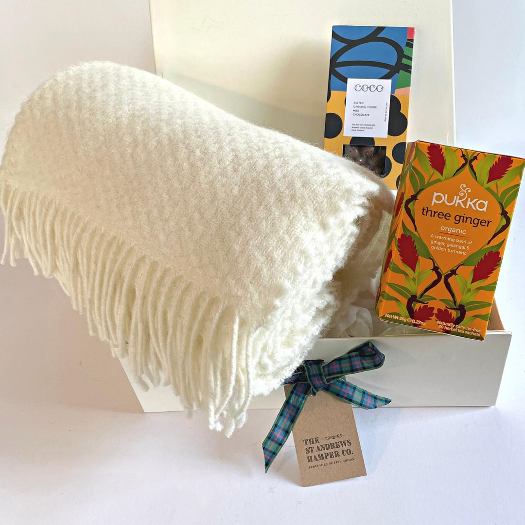 Gorgeous hygge hamper from The St Andrews Hamper Company, St Andrews, including a pure new wool armchair throw in ivory, Pukka organic herbal tea and artistically packaged milk chocolate coated fudge pieces by COCO Chocolatier, all beautifully presented in our signature luxury gift box.