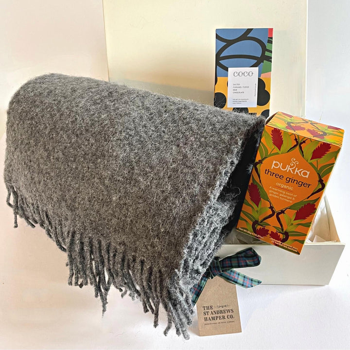 Gorgeous hygge hamper from The St Andrews Hamper Company, St Andrews, including a pure new wool armchair throw in slate grey, Pukka organic herbal tea and artistically packaged milk chocolate coated fudge pieces by COCO Chocolatier, all beautifully presented in our signature luxury gift box.