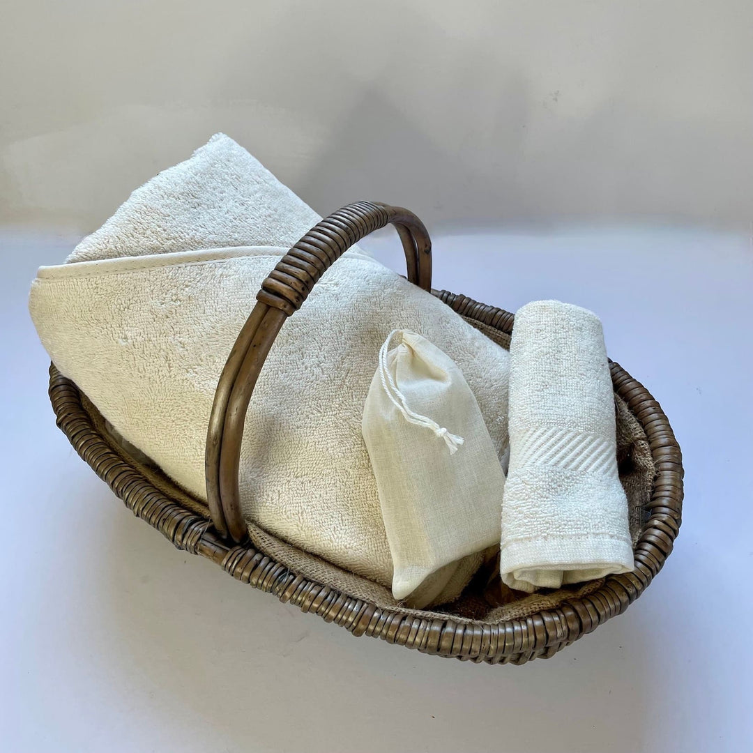 Organic baby bathtime set with a super soft hooded towel and body cloth and pure, natural soap in an oval shaped, hessian lined woven basket.