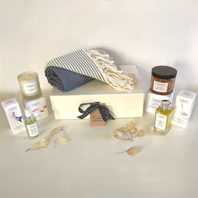 Indulgent Relax and Recharge Pamper Hamper from The St Andrews Hamper Company, filled with pure, natural organic spa candle, bath salts, body oil and pillow mist, plus an eco cotton hammam towel in indigo, all beautifully presented in a luxury keepsake gift box.