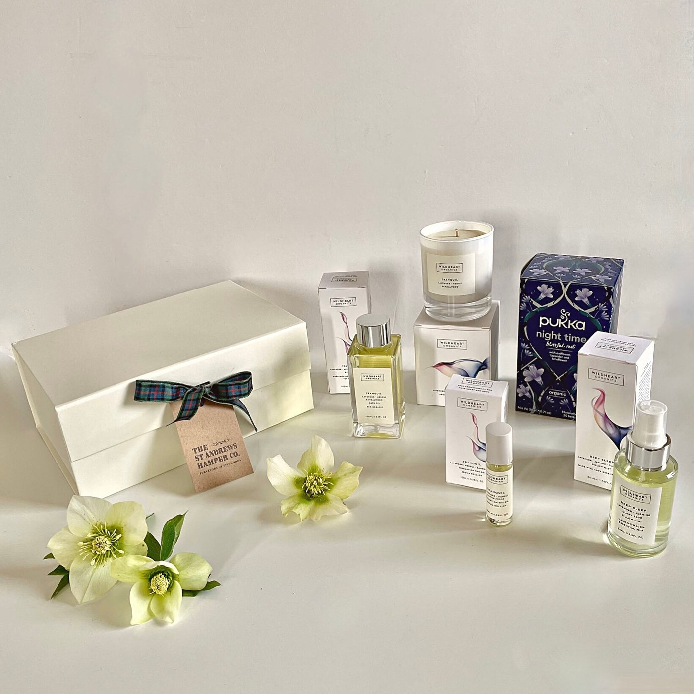 The St Andrews Hamper Company Sweet Dreams Organic Gift Box including bath and body oil, soy wax candle, pillow spray, aroma roll-on and herbal tea bags to aid restful sleep.